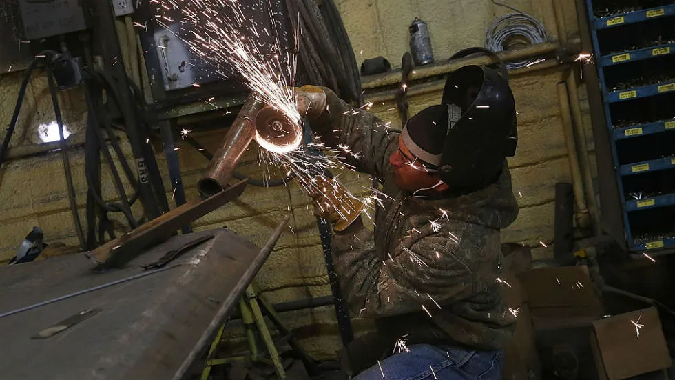 Father wearing welding gloves