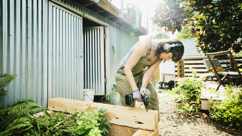 Mother wearing welding gloves