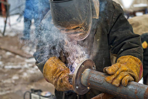 Wearing welding gloves while working in cold environments