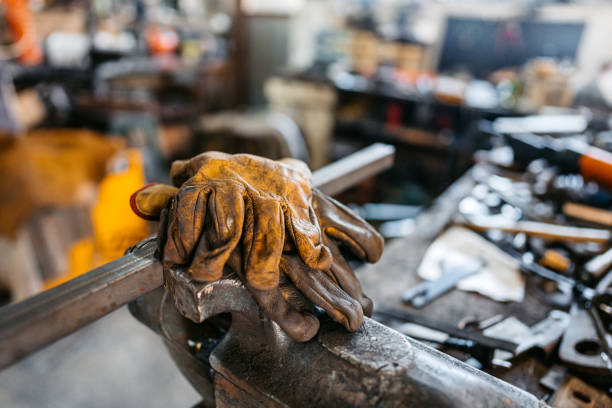 Welding gloves covered in oil stains and burn marks