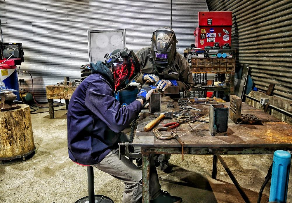 Welders socialize through welding gloves