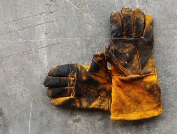 Welding gloves stained with oil and paint